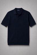 Men’s premium black ribbed knit polo shirt styled with tailored trousers and brown leather loafers by Thorvyn
