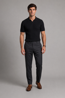 Men’s premium black ribbed knit polo shirt styled with tailored trousers and brown leather loafers by Thorvyn