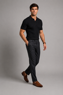 Men’s premium black ribbed knit polo shirt styled with tailored trousers and brown leather loafers by Thorvyn