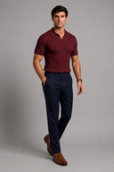 Men’s premium black ribbed knit polo shirt styled with tailored trousers and brown leather loafers by Thorvyn