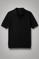 Men’s premium black ribbed knit polo shirt styled with tailored trousers and brown leather loafers by Thorvyn