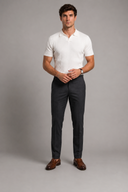 Men’s premium black ribbed knit polo shirt styled with tailored trousers and brown leather loafers by Thorvyn