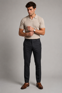 Men’s premium black ribbed knit polo shirt styled with tailored trousers and brown leather loafers by Thorvyn