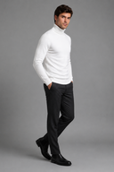 Men’s premium white roll neck knitted jumper styled with tailored trousers and black leather boots by Thorvyn