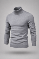 Men’s premium white roll neck knitted jumper styled with tailored trousers and black leather boots by Thorvyn