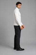 Men’s premium white roll neck knitted jumper styled with tailored trousers and black leather boots by Thorvyn