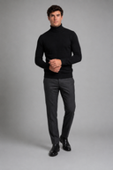 Men’s premium white roll neck knitted jumper styled with tailored trousers and black leather boots by Thorvyn