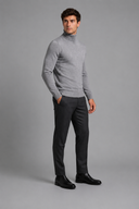 Men’s premium white roll neck knitted jumper styled with tailored trousers and black leather boots by Thorvyn