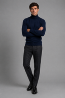 Men’s premium white roll neck knitted jumper styled with tailored trousers and black leather boots by Thorvyn