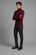 Men’s premium white roll neck knitted jumper styled with tailored trousers and black leather boots by Thorvyn