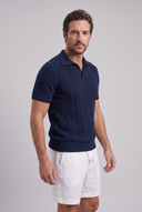 Men's textured knit polo featuring an open collar, vertical textured knit panels and ribbed trims.