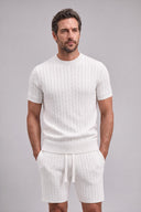 Men's matching cable knit set featuring a crew neck short-sleeve knit top with coordinating tailored knit shorts.