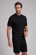Men's matching cable knit set featuring a crew neck short-sleeve knit top with coordinating tailored knit shorts.