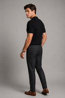 Men’s premium black ribbed knit polo shirt styled with tailored trousers and brown leather loafers by Thorvyn